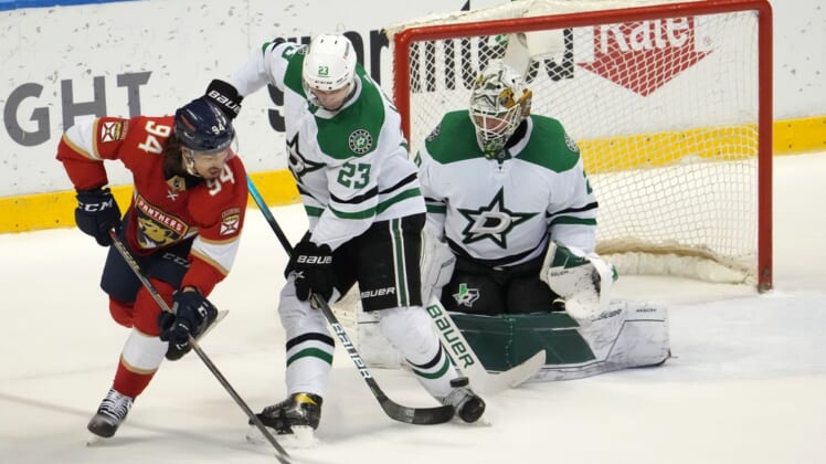 Jan 14, 2022; Sunrise, Florida, USA; Florida Panthers left wing Ryan Lomberg (94) attempts to redirect the puck in front of Dallas Stars defenseman Esa Lindell (23) and goaltender Jake Oettinger (29) during the first period at FLA Live Arena. Mandatory Credit: Jasen Vinlove-USA TODAY Sports