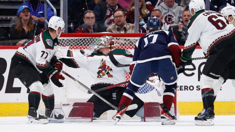 Jan 14, 2022; Denver, Colorado, USA; Colorado Avalanche center Tyson Jost (17) scores a goal past Arizona Coyotes goaltender Ivan Prosvetov (50) as defender Victor Soderstrom (77) looks on in the first period at Ball Arena. Mandatory Credit: Isaiah J. Downing-USA TODAY Sports