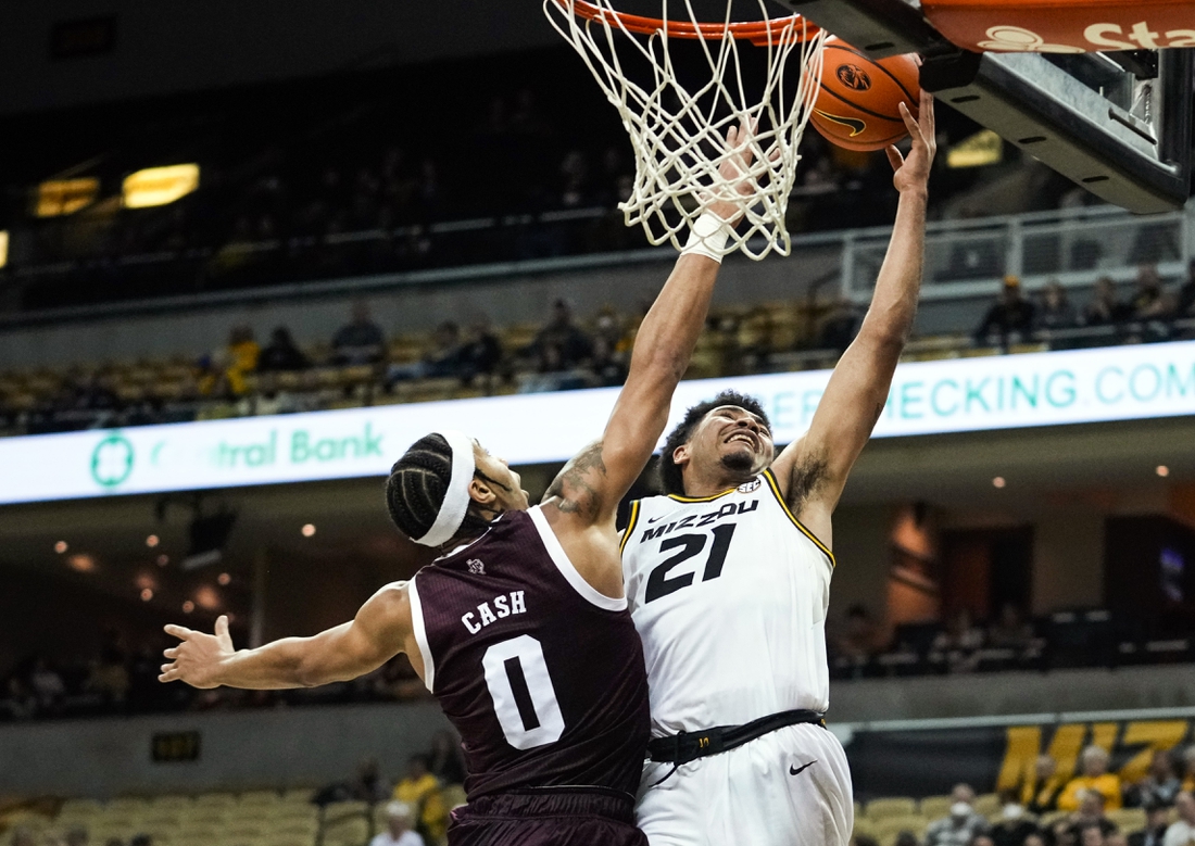 Jan 15, 2022; Columbia, Missouri, USA; Missouri Tigers forward Ronnie DeGray III (21) shoots as Texas A&M Aggies guard Aaron Cash (0) defends during the first half at Mizzou Arena. Mandatory Credit: Jay Biggerstaff-USA TODAY Sports