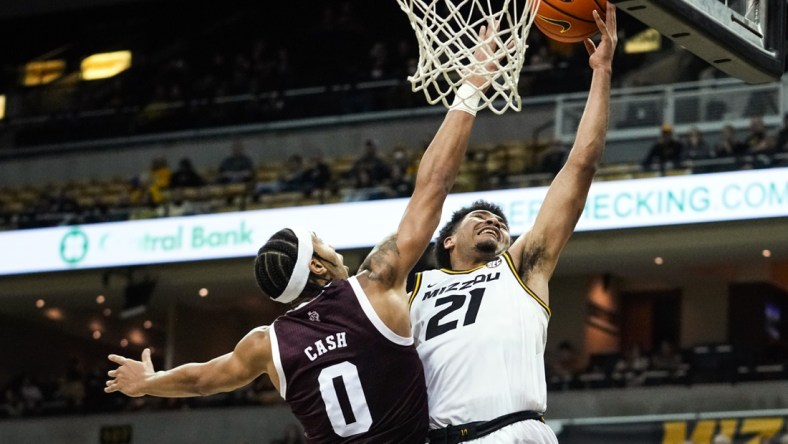 Jan 15, 2022; Columbia, Missouri, USA; Missouri Tigers forward Ronnie DeGray III (21) shoots as Texas A&M Aggies guard Aaron Cash (0) defends during the first half at Mizzou Arena. Mandatory Credit: Jay Biggerstaff-USA TODAY Sports