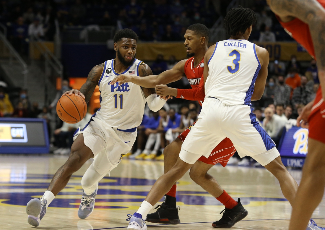 Jan 15, 2022; Pittsburgh, Pennsylvania, USA;  Pittsburgh Panthers guard Jamarius Burton (11) dribbles the ball against the Louisville Cardinals during the first half at Petersen Events Center. Mandatory Credit: Charles LeClaire-USA TODAY Sports