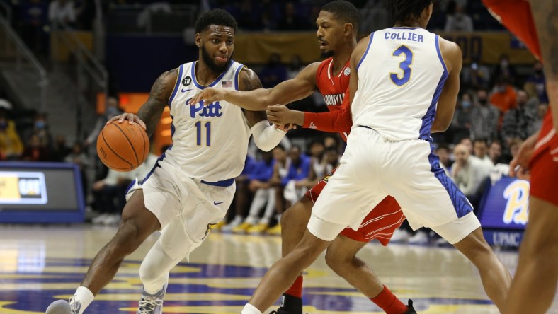 Jan 15, 2022; Pittsburgh, Pennsylvania, USA;  Pittsburgh Panthers guard Jamarius Burton (11) dribbles the ball against the Louisville Cardinals during the first half at Petersen Events Center. Mandatory Credit: Charles LeClaire-USA TODAY Sports