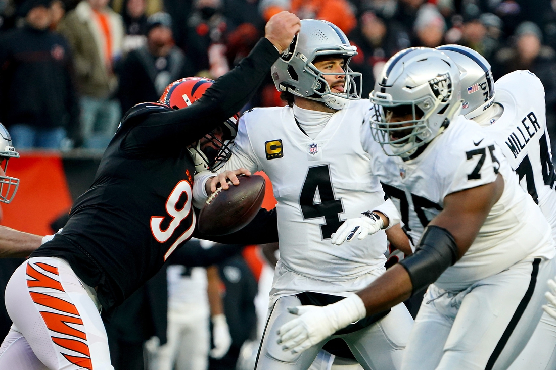 Cincinnati Bengals defensive end Trey Hendrickson (91) causes a sack and fumble of Las Vegas Raiders quarterback Derek Carr (4) in the first quarter during an NFL AFC wild-card playoff game, Saturday, Jan. 15, 2022, at Paul Brown Stadium in Cincinnati.

Las Vegas Raiders At Cincinnati Bengals Jan 15 Afc Wild Card Game