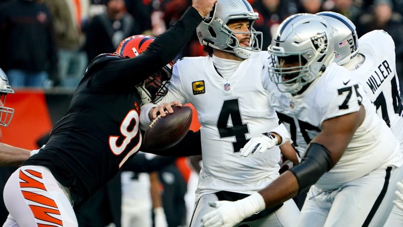 Cincinnati Bengals defensive end Trey Hendrickson (91) causes a sack and fumble of Las Vegas Raiders quarterback Derek Carr (4) in the first quarter during an NFL AFC wild-card playoff game, Saturday, Jan. 15, 2022, at Paul Brown Stadium in Cincinnati.

Las Vegas Raiders At Cincinnati Bengals Jan 15 Afc Wild Card Game