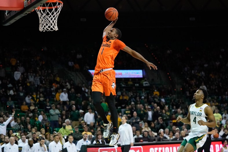 Jan 15, 2022; Waco, Texas, USA; Oklahoma State Cowboys guard Bryce Thompson (1) dunks the ball against the Baylor Bears during the first half at Ferrell Center. Mandatory Credit: Chris Jones-USA TODAY Sports