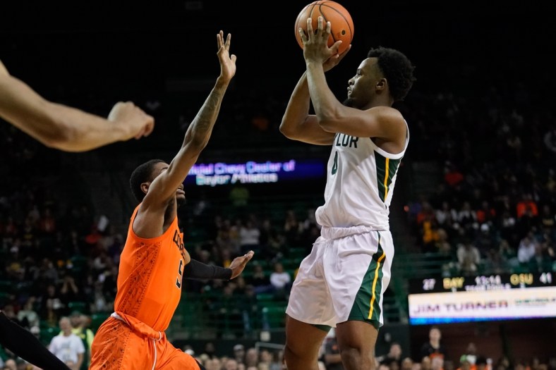 Jan 15, 2022; Waco, Texas, USA; Baylor Bears guard LJ Cryer (4) shoots the ball over Oklahoma State Cowboys guard Rondel Walker (5) during the second half at Ferrell Center. Mandatory Credit: Chris Jones-USA TODAY Sports