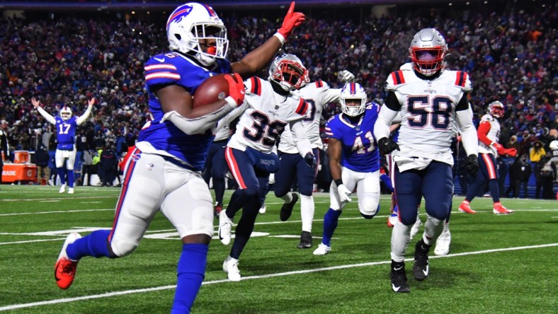 Jan 15, 2022; Orchard Park, New York, USA; Buffalo Bills running back Devin Singletary (26) runs for a touchdown during the second quarter of the AFC Wild Card playoff game against the New England Patriots at Highmark Stadium. Mandatory Credit: Mark Konezny-USA TODAY Sports