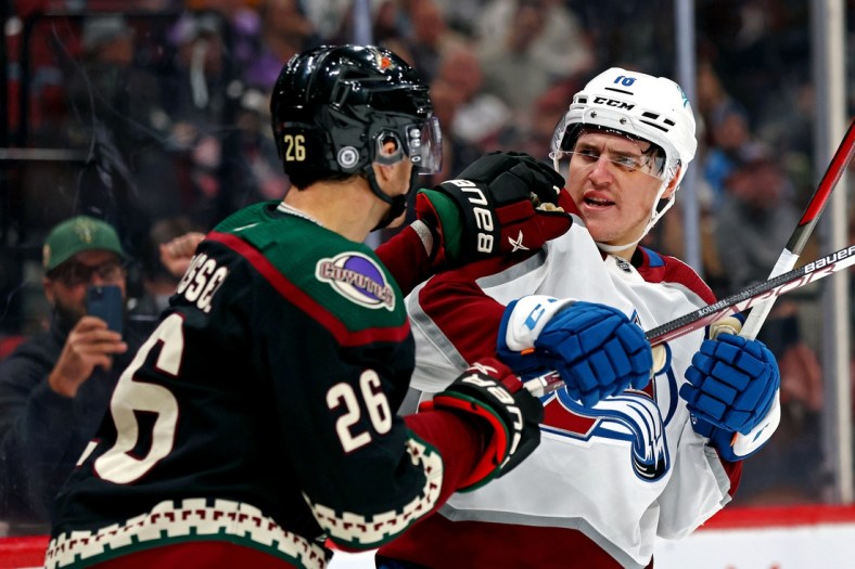 Jan 15, 2022; Glendale, Arizona, USA; Arizona Coyotes left wing Antoine Roussel (26) pushes Colorado Avalanche right wing Nicolas Aube-Kubel (16) during the second period at Gila River Arena. Mandatory Credit: Mark J. Rebilas-USA TODAY Sports