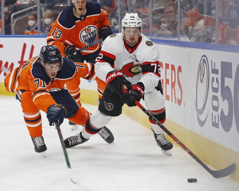 Jan 15, 2022; Edmonton, Alberta, CAN; Edmonton Oilers forward Ryan McLeod (71) and Ottawa Senators defensemen Thomas Chabot (72) chase a loose puck during the first period at Rogers Place. Mandatory Credit: Perry Nelson-USA TODAY Sports