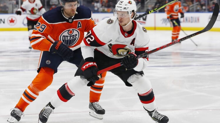 Jan 15, 2022; Edmonton, Alberta, CAN; Ottawa Senators defensemen Thomas Chabot (72) and Edmonton Oilers forward Leon Draisaitl (29) look for a loose puck during the third period at Rogers Place. Mandatory Credit: Perry Nelson-USA TODAY Sports