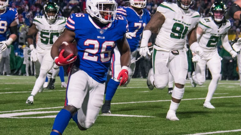 Jan 9, 2022; Orchard Park, New York, USA; Buffalo Bills running back Devin Singletary (26) runs for a touchdown in the fourth quarter against the New York Jets at Highmark Stadium. Mandatory Credit: Mark Konezny-USA TODAY Sports