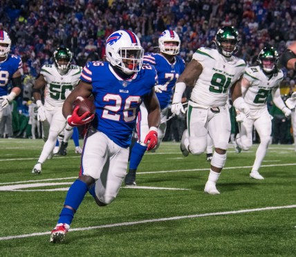 Jan 9, 2022; Orchard Park, New York, USA; Buffalo Bills running back Devin Singletary (26) runs for a touchdown in the fourth quarter against the New York Jets at Highmark Stadium. Mandatory Credit: Mark Konezny-USA TODAY Sports