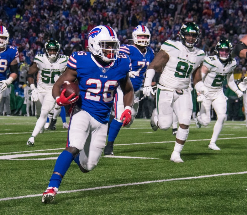 Jan 9, 2022; Orchard Park, New York, USA; Buffalo Bills running back Devin Singletary (26) runs for a touchdown in the fourth quarter against the New York Jets at Highmark Stadium. Mandatory Credit: Mark Konezny-USA TODAY Sports