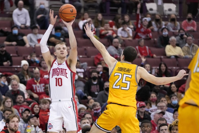 Ohio State Buckeyes forward Justin Ahrens (10) hits a three pointer over Towson Tigers guard Nicolas Timberlake (25) during the second half of the NCAA men's basketball game at Value City Arena in Columbus on Wednesday, Dec. 8, 2021.

Ahrens 1