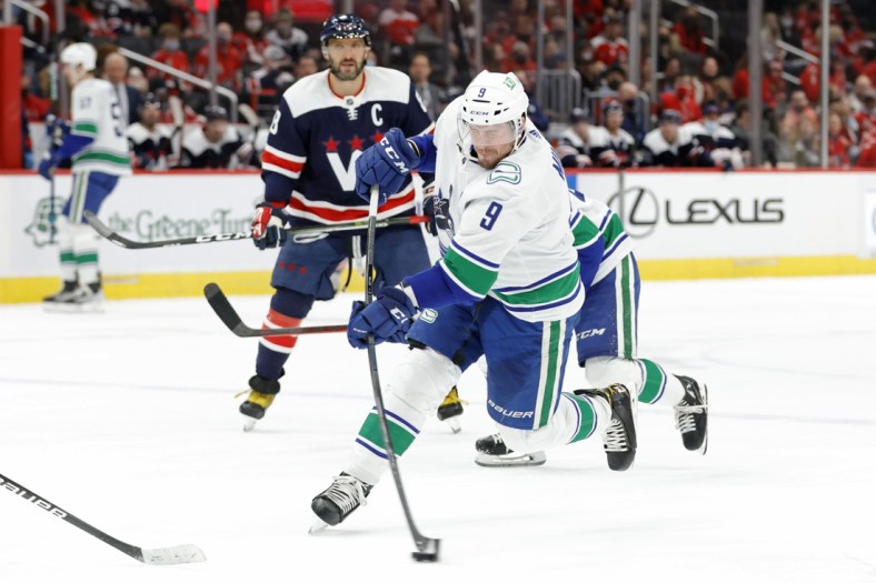 Jan 16, 2022; Washington, District of Columbia, USA; Vancouver Canucks center J.T. Miller (9) shoots the puck against the Washington Capitals during the second period at Capital One Arena. Mandatory Credit: Geoff Burke-USA TODAY Sports