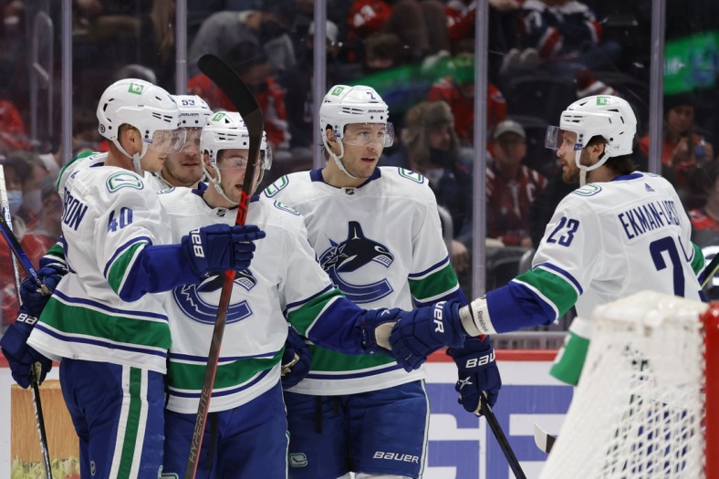 Jan 16, 2022; Washington, District of Columbia, USA; Vancouver Canucks center Elias Pettersson (40) celebrates with teammates after scoring a goal against the Washington Capitals during the second period at Capital One Arena. Mandatory Credit: Geoff Burke-USA TODAY Sports