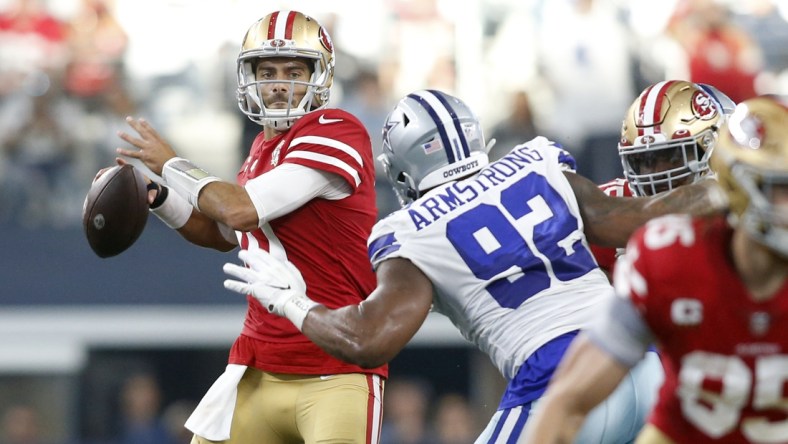 Jan 16, 2022; Arlington, Texas, USA; San Francisco 49ers quarterback Jimmy Garoppolo (10) throws the ball against Dallas Cowboys defensive end Dorance Armstrong (92) in the second quarter in a NFC Wild Card playoff football game at AT&T Stadium. Mandatory Credit: Tim Heitman-USA TODAY Sports