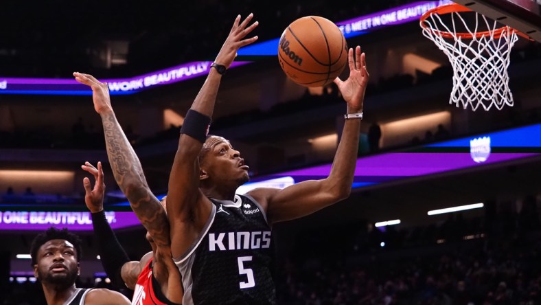 Jan 16, 2022; Sacramento, California, USA; Sacramento Kings guard De'Aaron Fox (5) controls a rebound against the Houston Rockets during the second quarter at Golden 1 Center. Mandatory Credit: Kelley L Cox-USA TODAY Sports