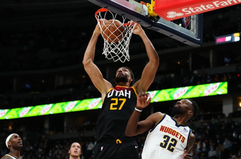 Jan 16, 2022; Denver, Colorado, USA; Utah Jazz center Rudy Gobert (27) dunks the ball over Denver Nuggets forward Jeff Green (32) in the second quarter at Ball Arena. Mandatory Credit: Ron Chenoy-USA TODAY Sports