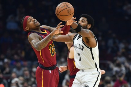 Jan 17, 2022; Cleveland, Ohio, USA; Brooklyn Nets guard Kyrie Irving (11) knocks the ball away from Cleveland Cavaliers guard Brandon Goodwin (26) during the first half at Rocket Mortgage FieldHouse. Mandatory Credit: Ken Blaze-USA TODAY Sports