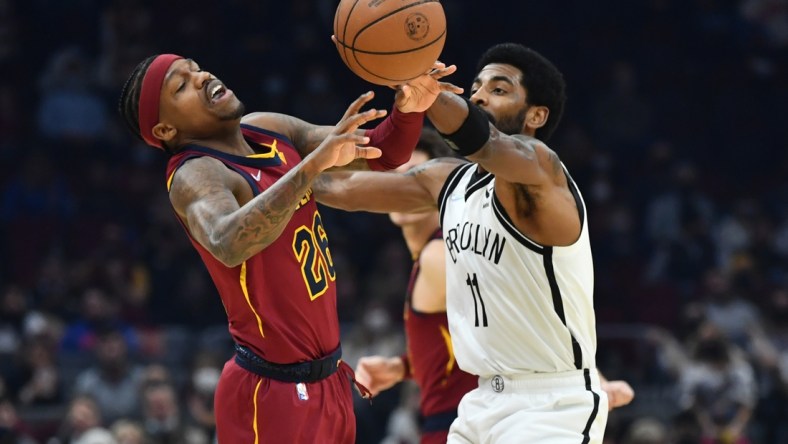 Jan 17, 2022; Cleveland, Ohio, USA; Brooklyn Nets guard Kyrie Irving (11) knocks the ball away from Cleveland Cavaliers guard Brandon Goodwin (26) during the first half at Rocket Mortgage FieldHouse. Mandatory Credit: Ken Blaze-USA TODAY Sports