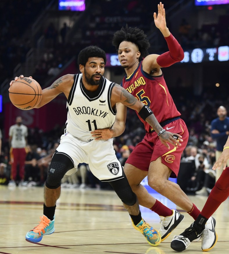 Jan 17, 2022; Cleveland, Ohio, USA; Cleveland Cavaliers forward Isaac Okoro (35) defends Brooklyn Nets guard Kyrie Irving (11) during the first half at Rocket Mortgage FieldHouse. Mandatory Credit: Ken Blaze-USA TODAY Sports