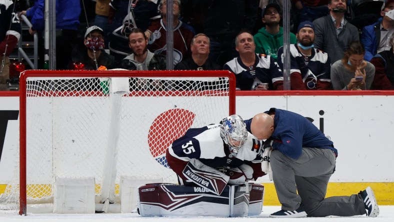 Jan 17, 2022; Denver, Colorado, USA; Colorado Avalanche goaltender Darcy Kuemper (35) is tended to by head athletic trainer Matt Sokolowski after a play in the second period against the Minnesota Wild at Ball Arena. Mandatory Credit: Isaiah J. Downing-USA TODAY Sports