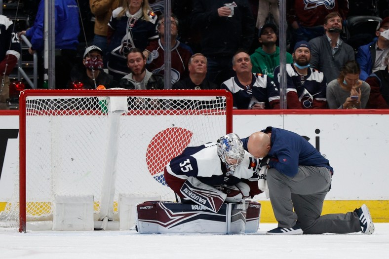 Jan 17, 2022; Denver, Colorado, USA; Colorado Avalanche goaltender Darcy Kuemper (35) is tended to by head athletic trainer Matt Sokolowski after a play in the second period against the Minnesota Wild at Ball Arena. Mandatory Credit: Isaiah J. Downing-USA TODAY Sports