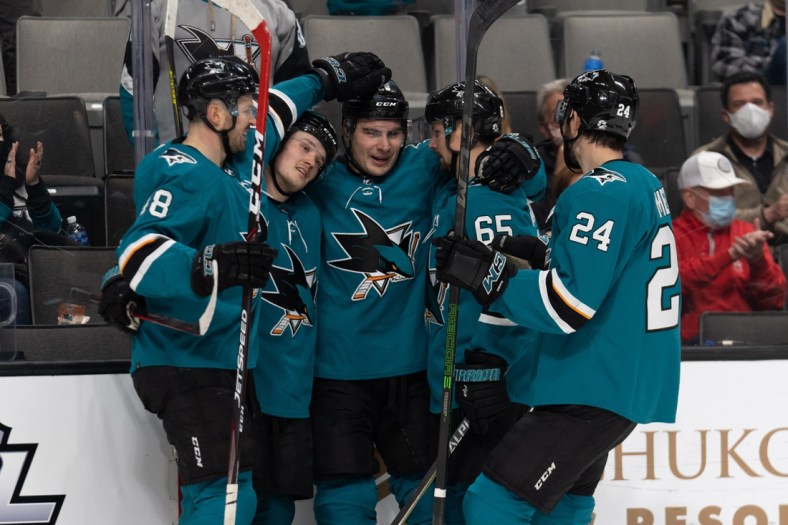 Jan 17, 2022; San Jose, California, USA; San Jose Sharks right wing Timo Meier (28) celebrates with center Tomas Hertl (48), left wing Rudolfs Balcers (92), defenseman Erik Karlsson (65) and defenseman Jaycob Megna (24) after scoring his fifth goal of the game during the second period against the Los Angeles Kings at SAP Center at San Jose. Mandatory Credit: Stan Szeto-USA TODAY Sports