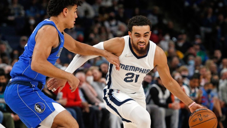 Jan 14, 2022; Memphis, Tennessee, USA; Memphis Grizzles guard Tyus Jones (21) dribbles as Dallas Mavericks guard Josh Green (8) defends during the first half at FedExForum. Mandatory Credit: Petre Thomas-USA TODAY Sports