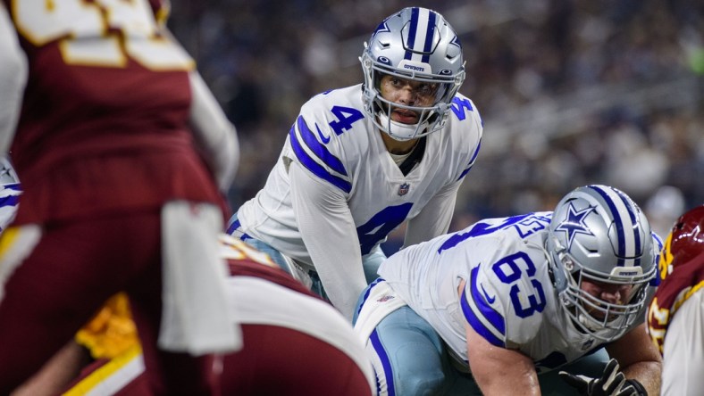 Dec 26, 2021; Arlington, Texas, USA; Dallas Cowboys quarterback Dak Prescott (4) and center Tyler Biadasz (63) in action during the game between the Washington Football Team and the Dallas Cowboys at AT&T Stadium. Mandatory Credit: Jerome Miron-USA TODAY Sports