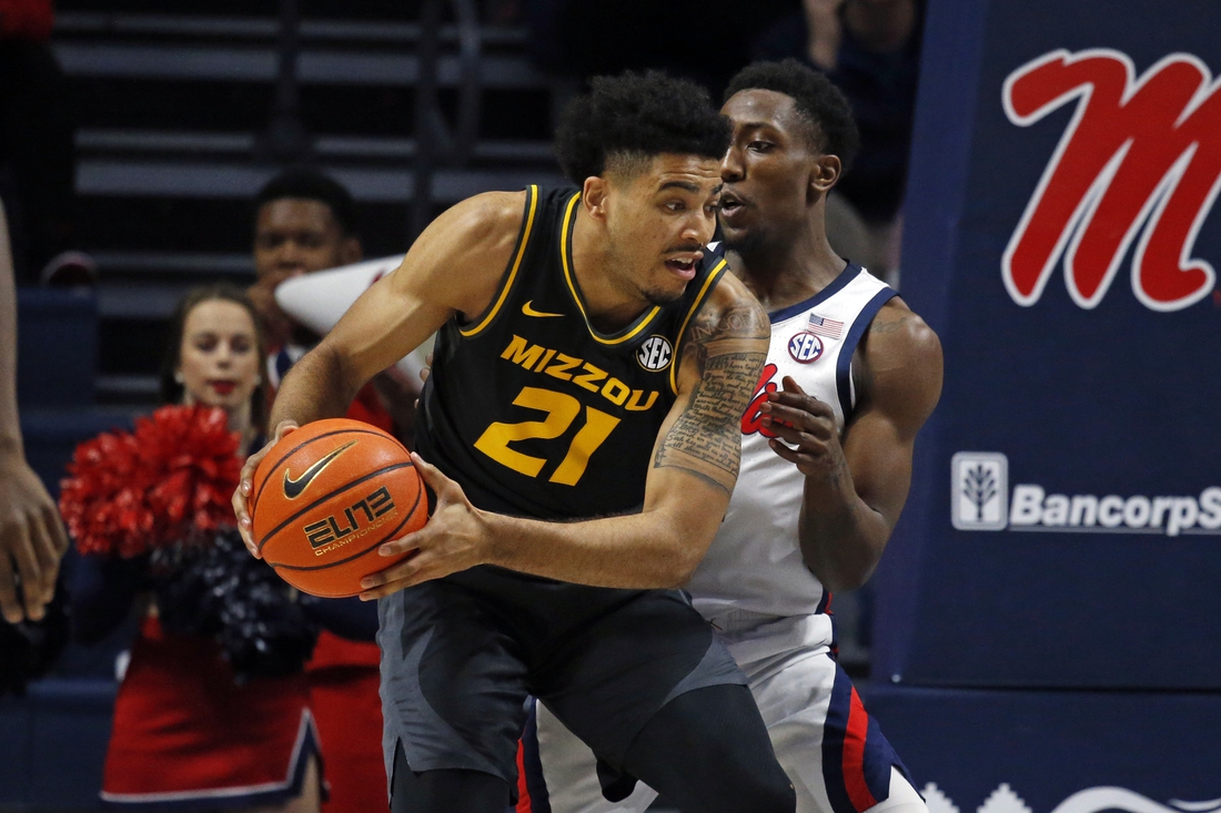 Jan 18, 2022; Oxford, Mississippi, USA; Missouri Tigers forward Ronnie DeGray III (21) spins toward the basket as Mississippi Rebels guard Tye Fagan (14) defends during the first half at The Sandy and John Black Pavilion at Ole Miss. Mandatory Credit: Petre Thomas-USA TODAY Sports