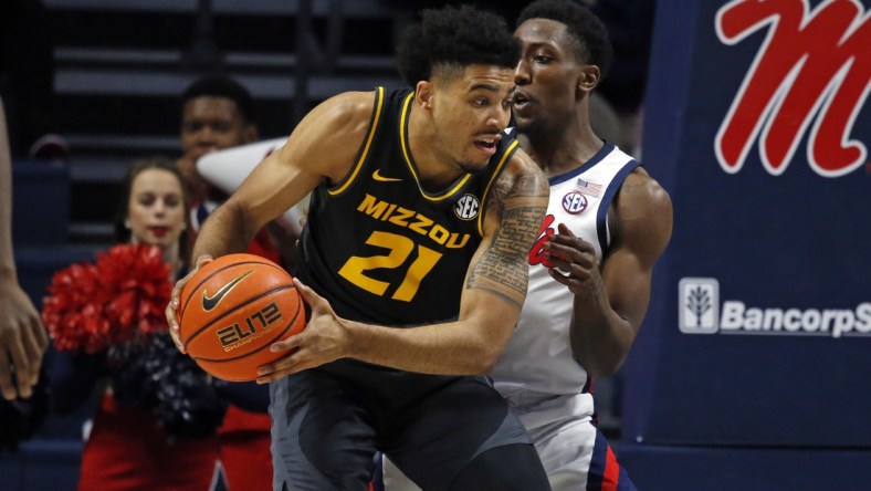 Jan 18, 2022; Oxford, Mississippi, USA; Missouri Tigers forward Ronnie DeGray III (21) spins toward the basket as Mississippi Rebels guard Tye Fagan (14) defends during the first half at The Sandy and John Black Pavilion at Ole Miss. Mandatory Credit: Petre Thomas-USA TODAY Sports