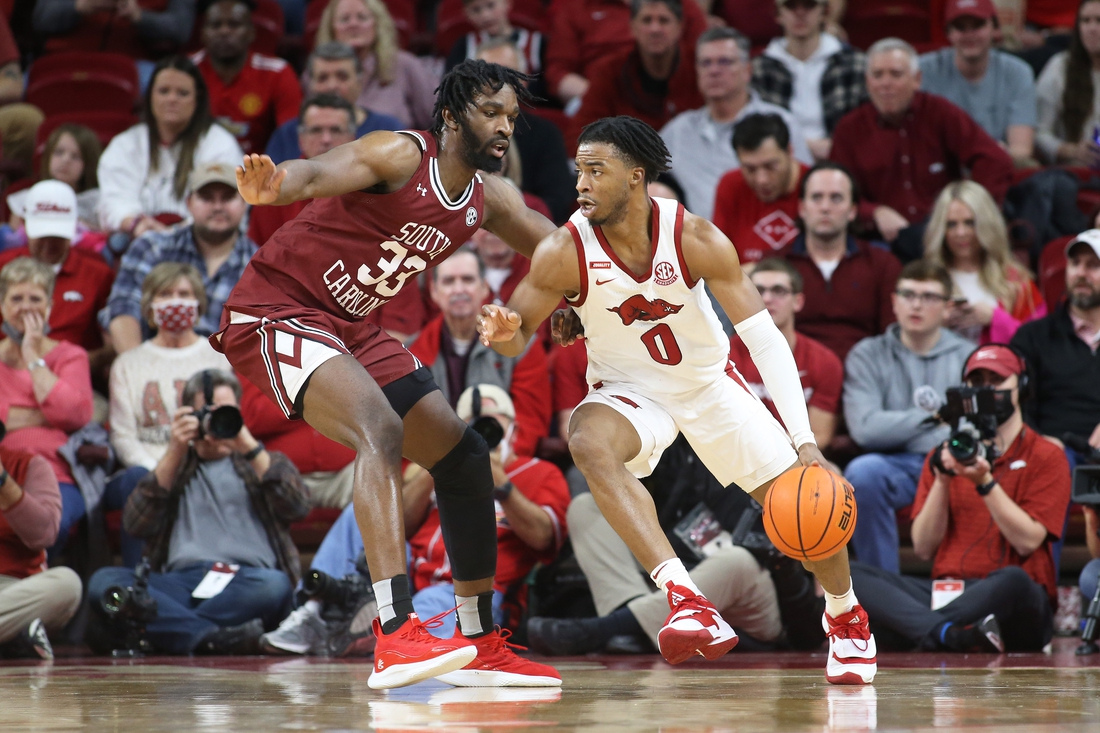 Jan 18, 2022; Fayetteville, Arkansas, USA; Arkansas Razorbacks guard Stanley Umude (0) drives against South Carolina Gamecocks forward Josh Gray (33) during the first half at Bud Walton Arena. Mandatory Credit: Nelson Chenault-USA TODAY Sports