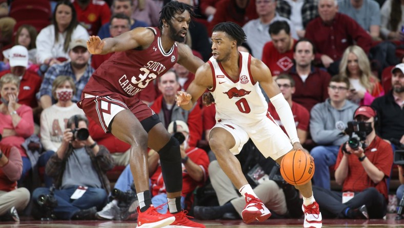 Jan 18, 2022; Fayetteville, Arkansas, USA; Arkansas Razorbacks guard Stanley Umude (0) drives against South Carolina Gamecocks forward Josh Gray (33) during the first half at Bud Walton Arena. Mandatory Credit: Nelson Chenault-USA TODAY Sports