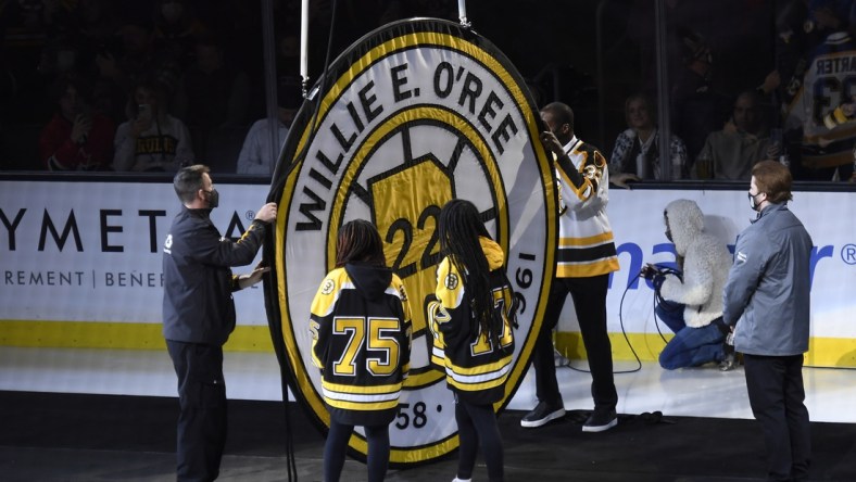 Jan 18, 2022; Boston, Massachusetts, USA;  Former Boston Bruins player Willie O Ree has his number retired and raised to the rafters prior to a game against the Carolina Hurricanes at TD Garden. Mandatory Credit: Bob DeChiara-USA TODAY Sports