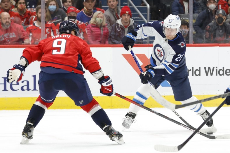 Jan 18, 2022; Washington, District of Columbia, USA; Winnipeg Jets left wing Nikolaj Ehlers (27) shoots the puck as Washington Capitals defenseman Dmitry Orlov (9) defends during the second period at Capital One Arena. Mandatory Credit: Geoff Burke-USA TODAY Sports