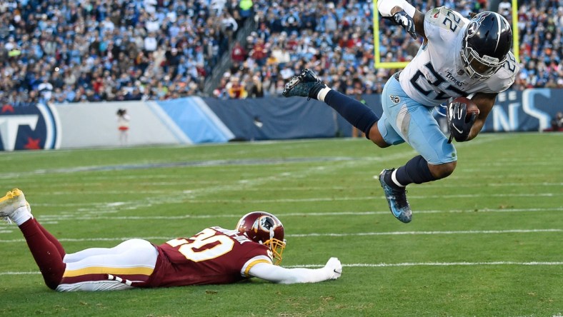 Titans running back Derrick Henry (22) flies past Redskins safety Ha Ha Clinton-Dix (20) as he heads in for the team's first touchdown in the first quarter Nissan Stadium Saturday, Dec. 22, 2018, in Nashville, Tenn.

Spac 6152022827 Henry