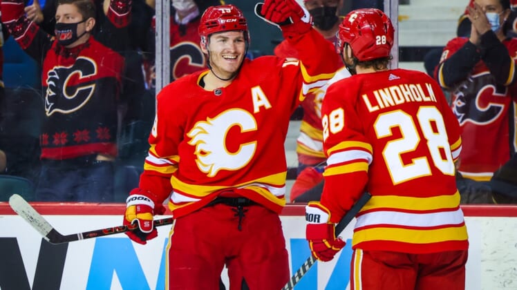 Jan 18, 2022; Calgary, Alberta, CAN; Calgary Flames left wing Matthew Tkachuk (19) scores a goal with center Elias Lindholm (28) against the Florida Panthers during the third period at Scotiabank Saddledome. Mandatory Credit: Sergei Belski-USA TODAY Sports