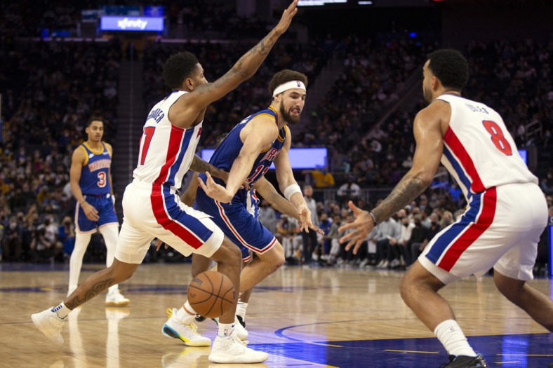 Jan 18, 2022; San Francisco, California, USA; Golden State Warriors guard Klay Thompson (11) passes around Detroit Pistons guard Rodney McGruder (17) during the fourth quarter at Chase Center. Mandatory Credit: D. Ross Cameron-USA TODAY Sports