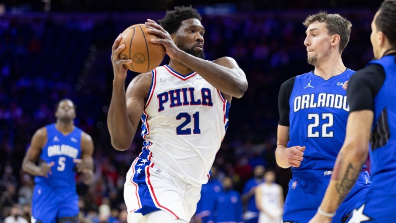 Jan 19, 2022; Philadelphia, Pennsylvania, USA; Philadelphia 76ers center Joel Embiid (21) drives against Orlando Magic forward Franz Wagner (22) during the first quarter at Wells Fargo Center. Mandatory Credit: Bill Streicher-USA TODAY Sports