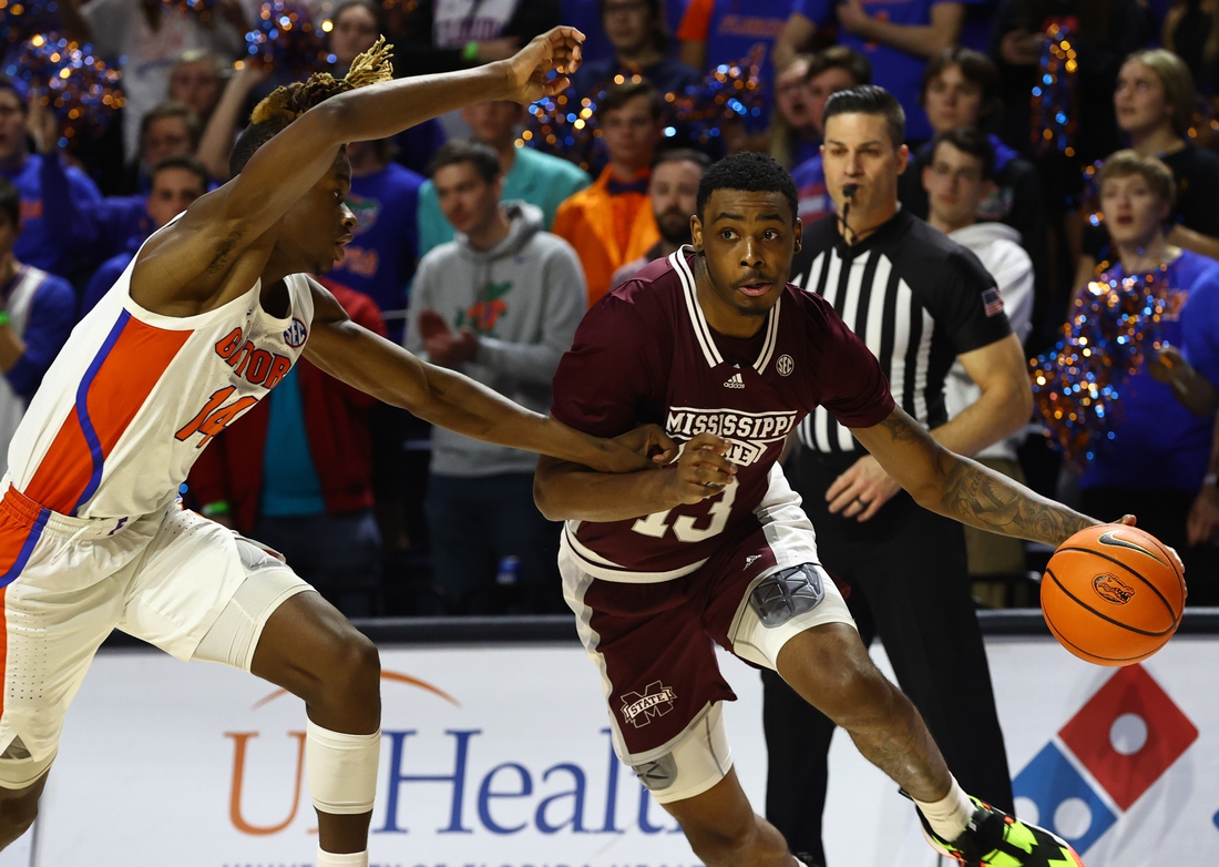 Jan 19, 2022; Gainesville, Florida, USA; Mississippi State Bulldogs forward D.J. Jeffries (13) drives to the basket as Florida Gators guard Kowacie Reeves (14) defends during the first half at Billy Donovan Court at Exactech Arena. Mandatory Credit: Kim Klement-USA TODAY Sports