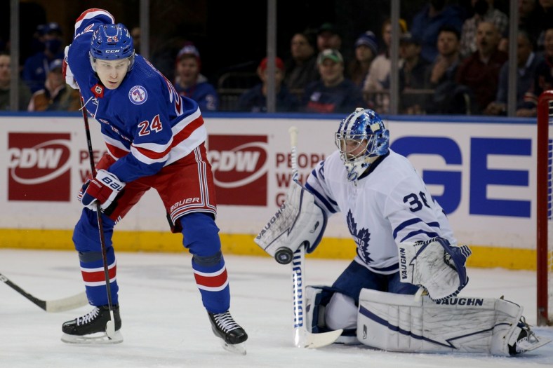 Jan 19, 2022; New York, New York, USA; New York Rangers right wing Kaapo Kakko (24) plays the puck in front of Toronto Maple Leafs goaltender Jack Campbell (36) during the first period at Madison Square Garden. Mandatory Credit: Brad Penner-USA TODAY Sports