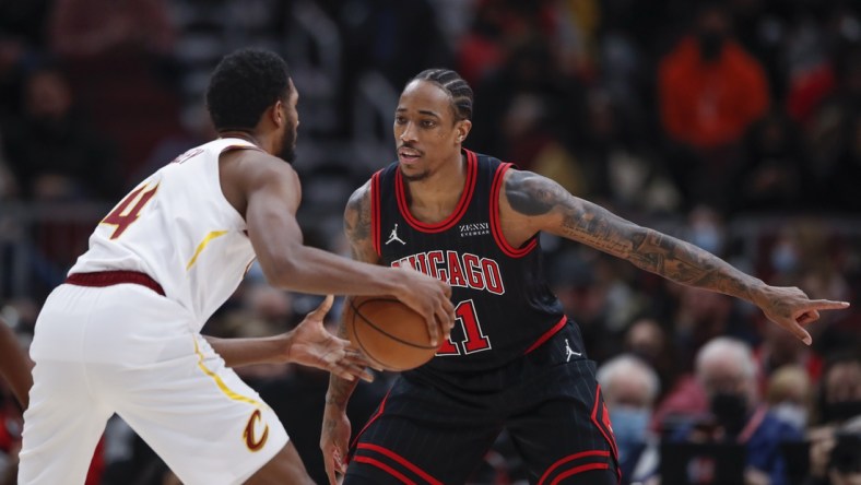 Jan 19, 2022; Chicago, Illinois, USA; Chicago Bulls forward DeMar DeRozan (11) defends against Cleveland Cavaliers center Evan Mobley (4) during the first half at United Center. Mandatory Credit: Kamil Krzaczynski-USA TODAY Sports