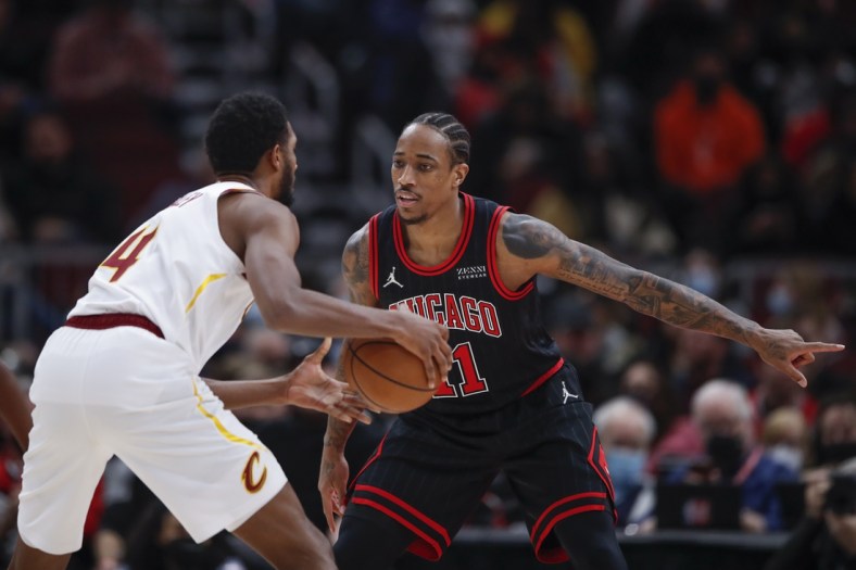 Jan 19, 2022; Chicago, Illinois, USA; Chicago Bulls forward DeMar DeRozan (11) defends against Cleveland Cavaliers center Evan Mobley (4) during the first half at United Center. Mandatory Credit: Kamil Krzaczynski-USA TODAY Sports