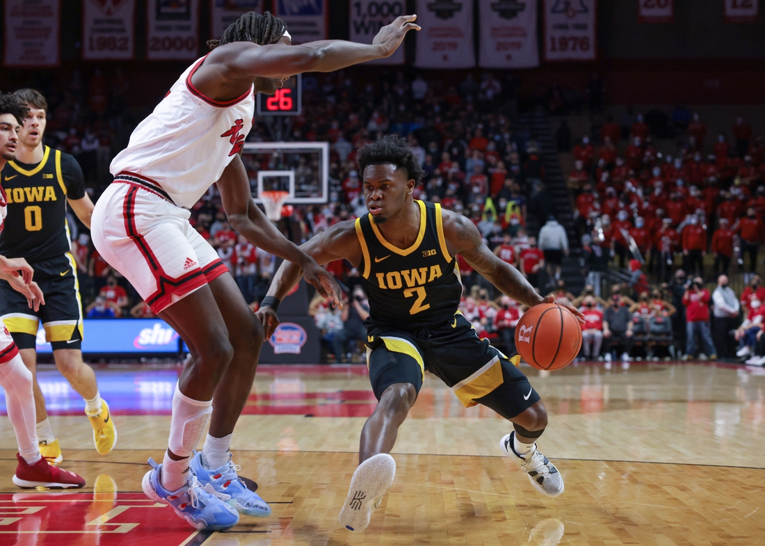 Jan 19, 2022; Piscataway, New Jersey, USA; Iowa Hawkeyes guard Joe Toussaint (2) dribbles against Rutgers Scarlet Knights center Clifford Omoruyi (11) during the first half at Jersey Mike's Arena. Mandatory Credit: Vincent Carchietta-USA TODAY Sports