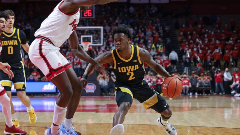 Jan 19, 2022; Piscataway, New Jersey, USA; Iowa Hawkeyes guard Joe Toussaint (2) dribbles against Rutgers Scarlet Knights center Clifford Omoruyi (11) during the first half at Jersey Mike's Arena. Mandatory Credit: Vincent Carchietta-USA TODAY Sports