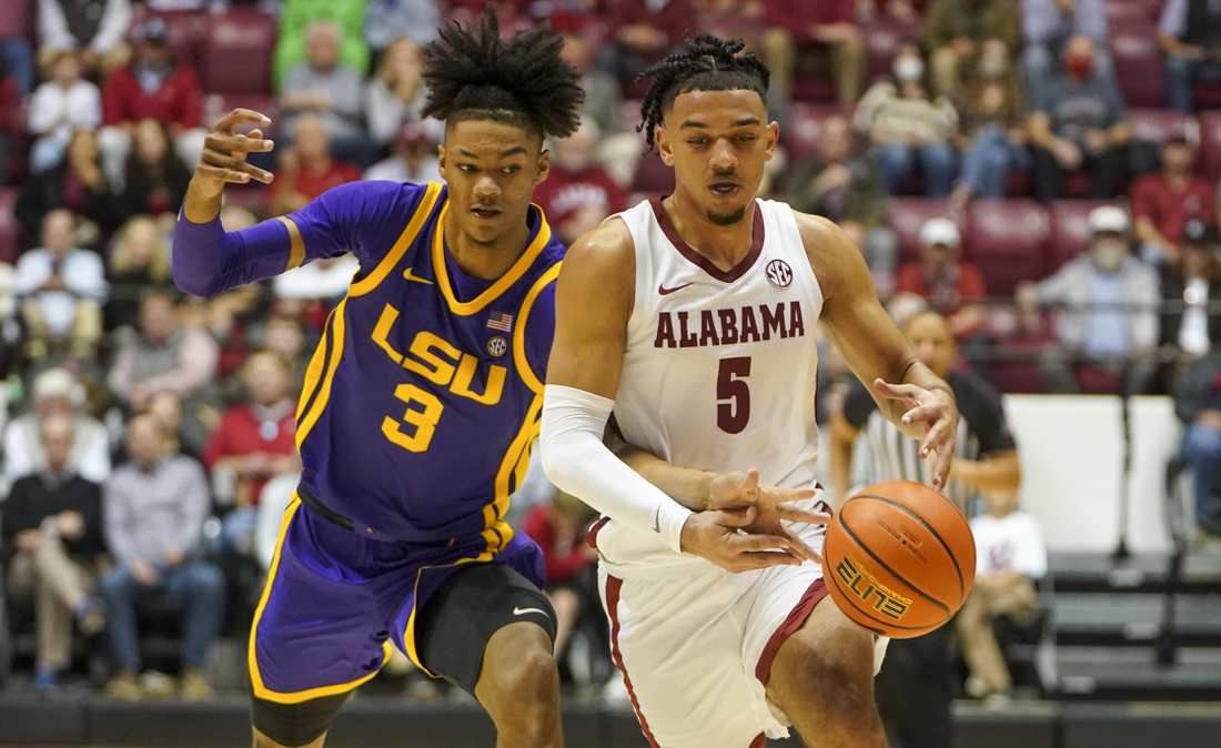 Jan 19, 2022; Tuscaloosa, Alabama, USA; LSU Tigers forward Alex Fudge (3) reaches for the ball from Alabama Crimson Tide guard Jaden Shackelford (5) during the second half at Coleman Coliseum. Mandatory Credit: Marvin Gentry-USA TODAY Sports