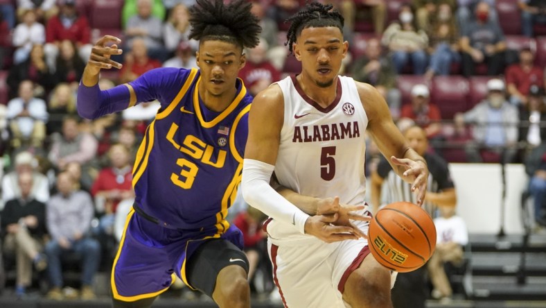 Jan 19, 2022; Tuscaloosa, Alabama, USA; LSU Tigers forward Alex Fudge (3) reaches for the ball from Alabama Crimson Tide guard Jaden Shackelford (5) during the second half at Coleman Coliseum. Mandatory Credit: Marvin Gentry-USA TODAY Sports