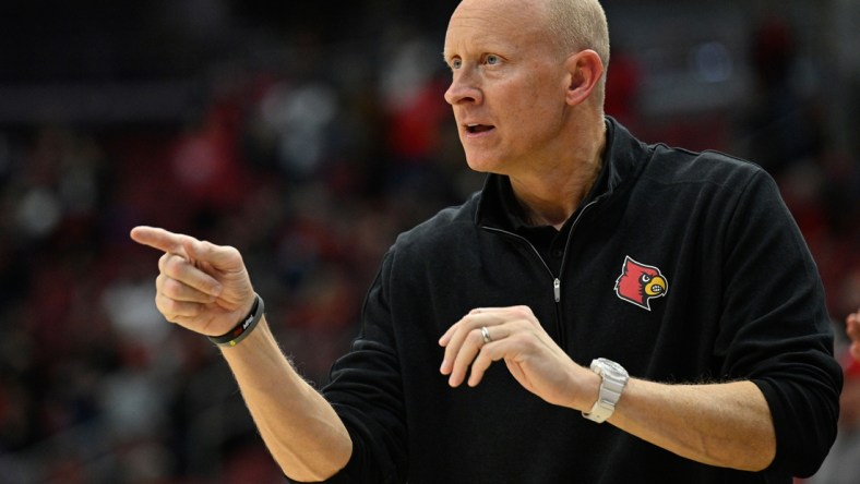 Jan 12, 2022; Louisville, Kentucky, USA;  Louisville Cardinals head coach Chris Mack gives instructions during the second half against the North Carolina State Wolfpack at KFC Yum! Center. N.C. State defeated Louisville 79-63. Mandatory Credit: Jamie Rhodes-USA TODAY Sports